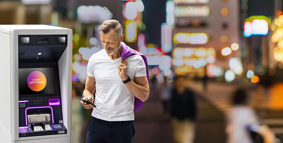 Man using phone in front of DN Series ATM